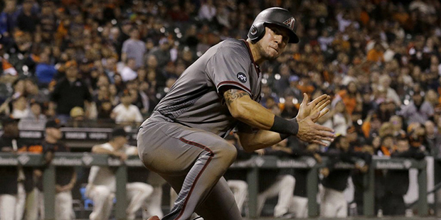 Arizona Diamondbacks' David Peralta reacts after scoring against the San Francisco Giants during th...