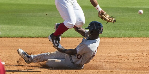 Auburn's Anfernee Grier, bottom, slides safely under Alabama infielder Cobie Vance, top, for a stol...