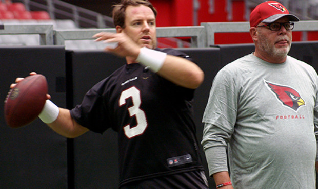 QB Carson Palmer and head coach Bruce Arians talk prior to training camp July 30. (Photo by Adam Gr...