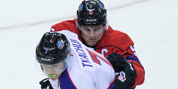 Team Cherry's Jakob Chychrun, top, checks Team Orr's Matthew Tkachuk during first-period CHL/NHL To...