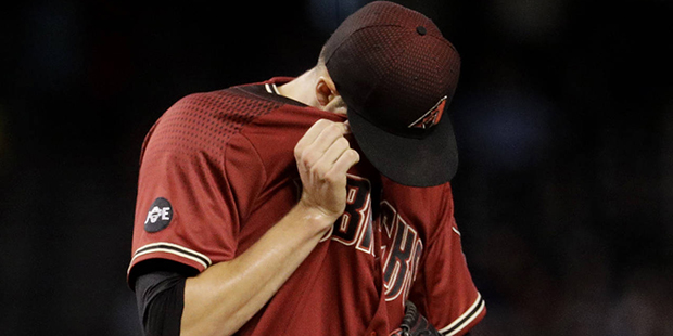 Arizona Diamondbacks starting pitcher Patrick Corbin (46) wipes his face after giving up a two run ...