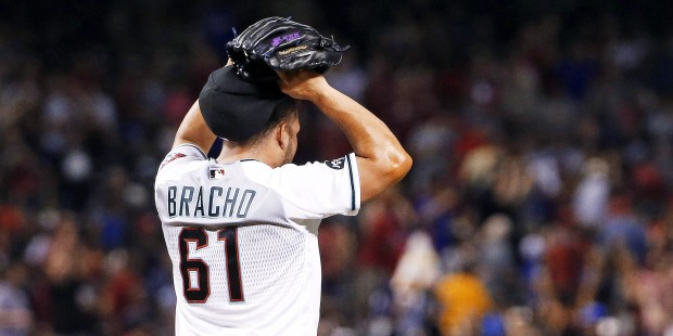 Arizona Diamondbacks' Silvino Bracho puts his hands on his head after giving up a grand slam to Los...