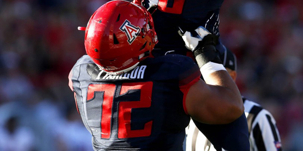 Arizona quarterback Jerrard Randall (8) celebrates with teammate Freddie Tagaloa after throwing a t...