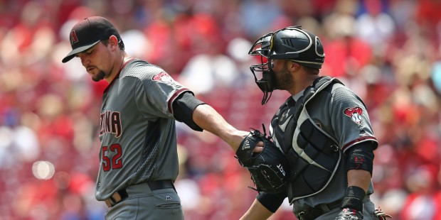 Arizona Diamondbacks starting pitcher Zack Godley, left, talks with catcher Welington Castillo, rig...