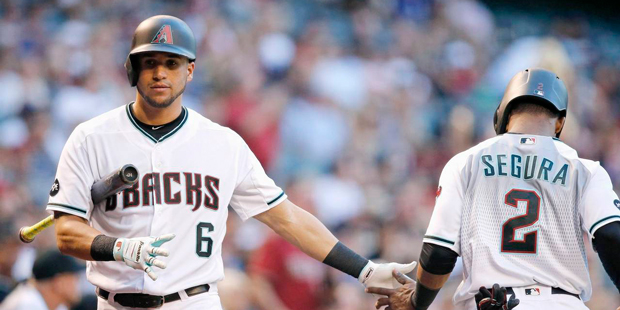 Arizona Diamondbacks' Jean Segura (2) slaps hands with David Peralta (6) after Segura scored a run ...