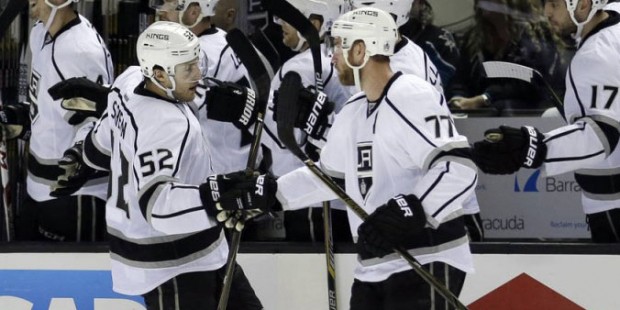 Los Angeles Kings' Luke Schenn (52) is congratulated by Jeff Carter (77) after scoring a goal again...