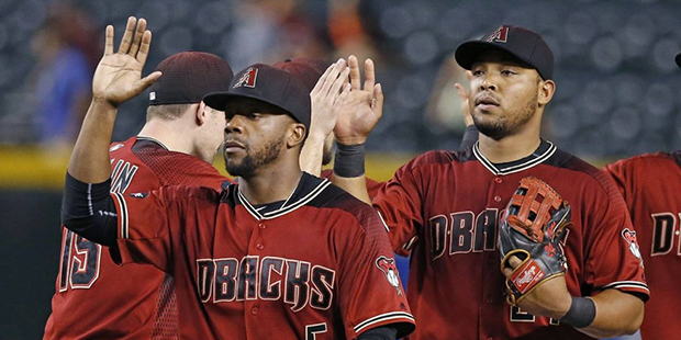 Arizona Diamondbacks' Rickie Weeks Jr. (5) and Yasmany Tomas, right, celebrate with teammates after...