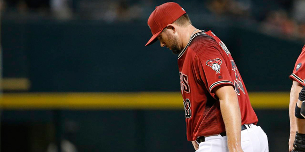 Arizona Diamondbacks pitcher Jake Barrett walks off the field after being replaced during the ninth...