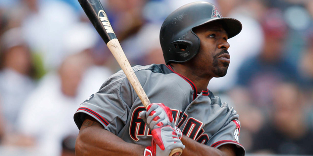Arizona Diamondbacks' Michael Bourn follows the flight of his two-run home run off Colorado Rockies...