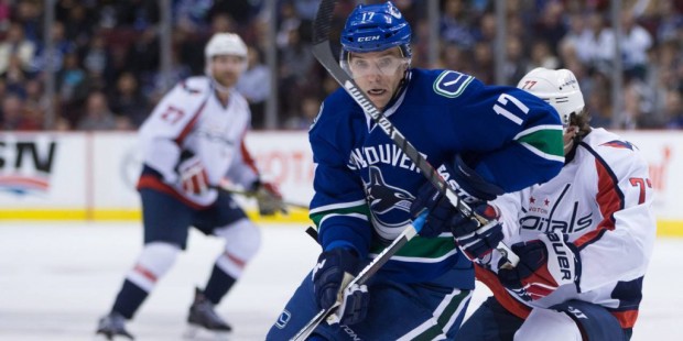 Vancouver Canucks' Radim Vrbata (17), of the Czech Republic, is checked by Washington Capitals' T.J...