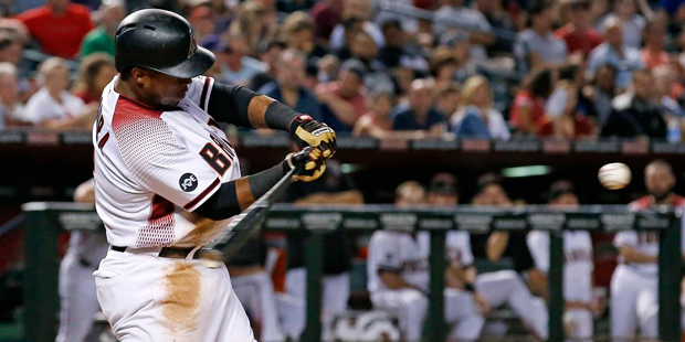 Arizona Diamondbacks' Jean Segura watches the baseball just before connecting on a run-scoring doub...
