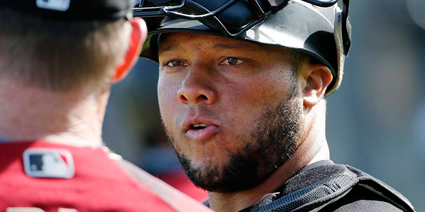 Arizona Diamondbacks' Welington Castillo, right, talks with bench coach Glenn Sherlock, left, durin...