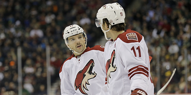 Phoenix Coyotes right wing Radim Vrbata, left, of the Czech Republic, talks with center Martin Hanz...