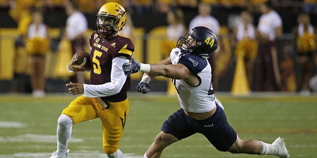 Arizona State's Manny Wilkins (5) runs past Northern Arizona's Jake Thomas (44) during the second h...