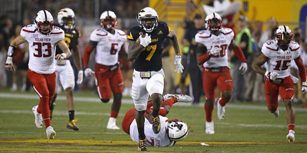 Arizona State's Kalen Ballage (7) runs past Texas Tech defenders Brayden Stringer (33), Kris Willia...