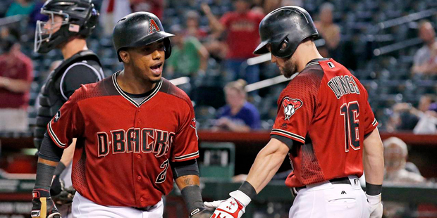 Arizona Diamondbacks' Jean Segura, left, celebrates his home run against the Colorado Rockies with ...