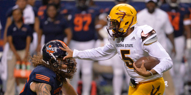 Arizona State quarterback Manny Wilkins (5) pushes off against UTSA linebacker Josiah Tauaefa durin...