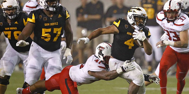 Arizona State's Demario Richard (4) runs for a first down as he drags Texas Tech's Malik Jenkins (4...