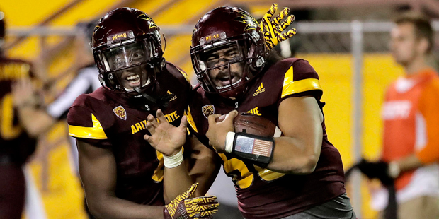 Arizona State linebacker Salamo Fiso, right, celebrates his interception with De'Chavon Hayes durin...
