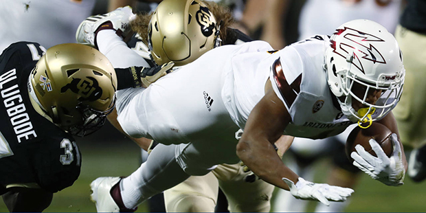 Arizona State running back Demario Richard, front, is stopped by Colorado Buffaloes linebackers Ken...