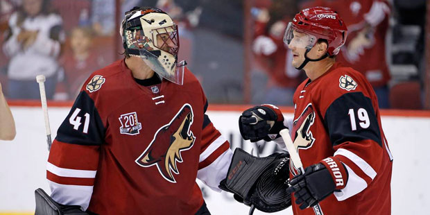 Arizona Coyotes' Mike Smith (41) and Shane Doan (19) celebrate the Coyotes' 3-1 win over the San Jo...