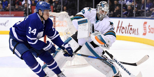 Toronto Maple Leafs centre Auston Matthews (34) checks San Jose Sharks goalie Martin Jones (31) as ...