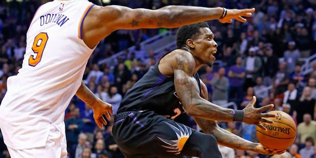 Phoenix Suns guard Eric Bledsoe, right, slips past New York Knicks center Kyle O'Quinn (9) to score...