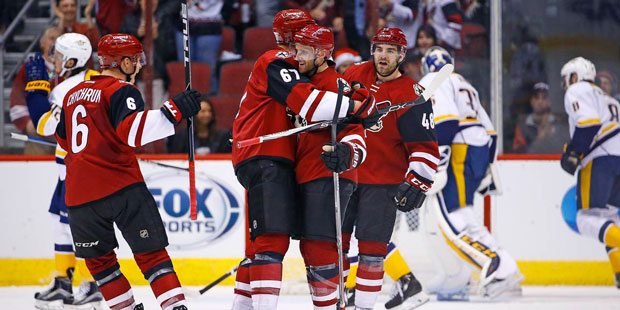 Arizona Coyotes defenseman Alex Goligoski, center, celebrates his goal against the Nashville Predat...