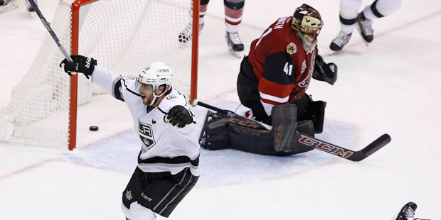 Los Angeles Kings center Anze Kopitar (11) celebrates a goal by teammate Trevor Lewis against Arizo...