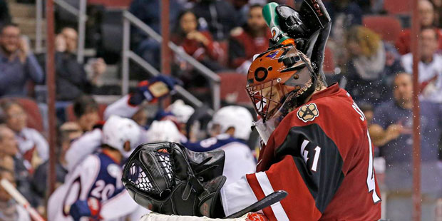 As Columbus Blue Jackets celebrate a goal by center Alexander Wennberg, Arizona Coyotes goalie Mike...