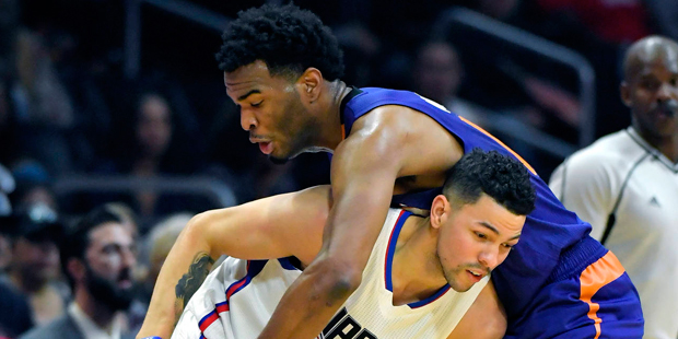 Phoenix Suns forward T.J. Warren, right, reach over Los Angeles Clippers guard Austin Rivers for th...