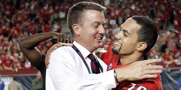 Arizona's Athletic Director Greg Byrne, left, and starting quarterback Matt Scott (10) share a hug ...