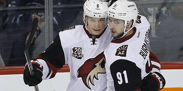 Arizona Coyotes' Jakob Chychrun (6) and Alexander Burmistrov (91) celebrate Chychrun's goal against...