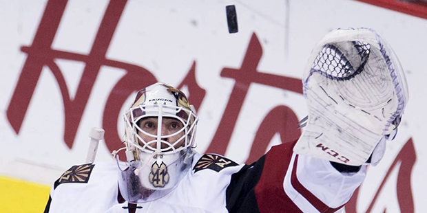 Arizona Coyotes goalie Mike Smith (41) makes a save during second period NHL action against the Van...