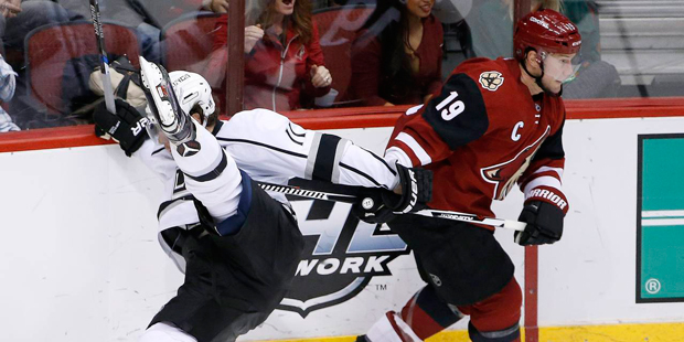Arizona Coyotes' Shane Doan (19) sends Los Angeles Kings' Anze Kopitar, left, of Slovenia, to the i...
