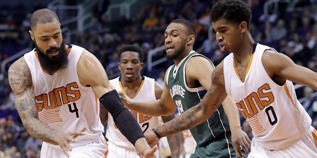 Phoenix Suns center Tyson Chandler (4) and forward Marquese Chriss (0) chase down the lose ball as ...