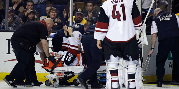 Arizona Coyotes center Alexander Burmistrov (91) flashes a thumbs-up as he is taken off the ice on ...