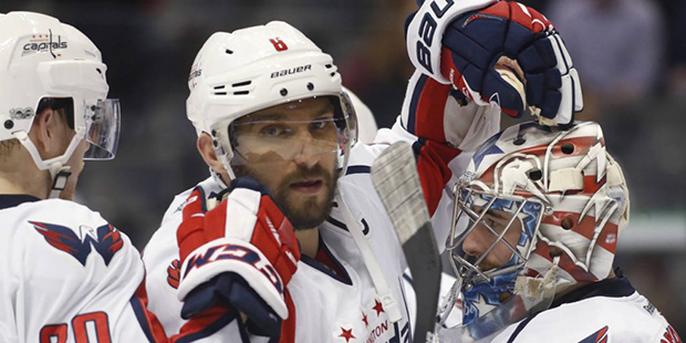 Washington Capitals left wing Alex Ovechkin, center, of Russia, and center Lars Eller, left, of Den...