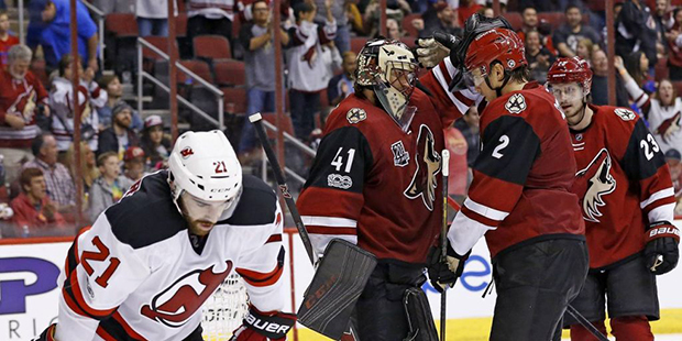 Arizona Coyotes goalie Mike Smith (41) celebrates a win with defenseman Luke Schenn (2) and defense...