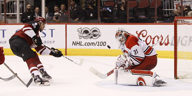Carolina Hurricanes goalie Eddie Lack (31) blocks the shot of Arizona Coyotes' Tobias Rieder for a ...