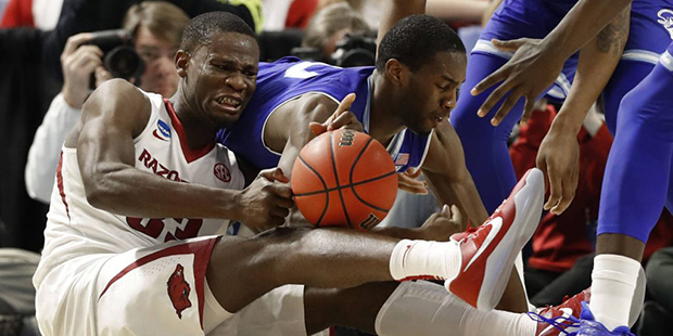 Arkansas's Moses Kingsley (33) and Seton Hall's Khadeen Carrington (0) battle for a loose ball duri...