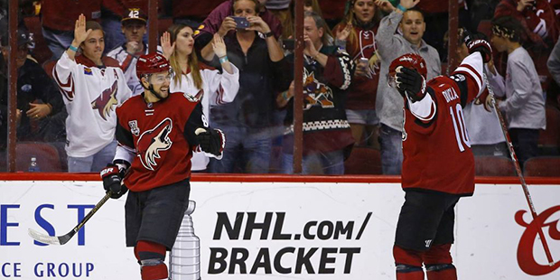 Arizona Coyotes' Josh Jooris, left, celebrates his goal against the Washington Capitals with Anthon...