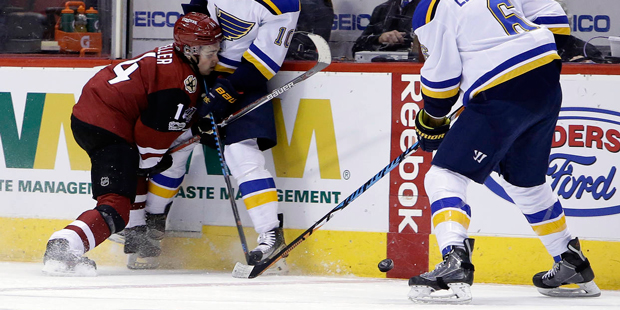 Arizona Coyotes center Clayton Keller (14) and St. Louis Blues right wing Scottie Upshall (10) batt...