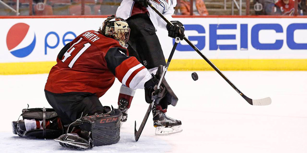 Arizona Coyotes goalie Mike Smith (41) makes a save on a shot as Colorado Avalanche center Joe Colb...
