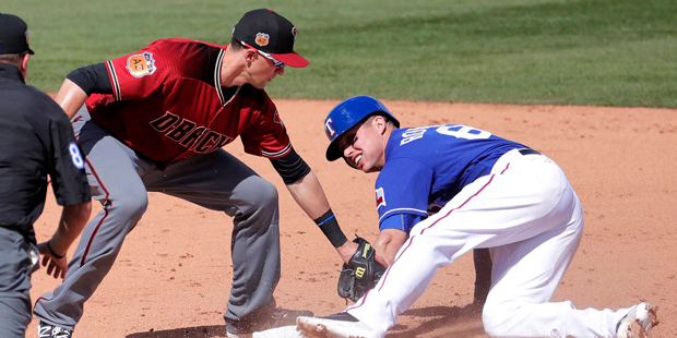 Texas Rangers' Drew Robinson steals second as Arizona Diamondbacks' Nick Ahmed applies the late tag...