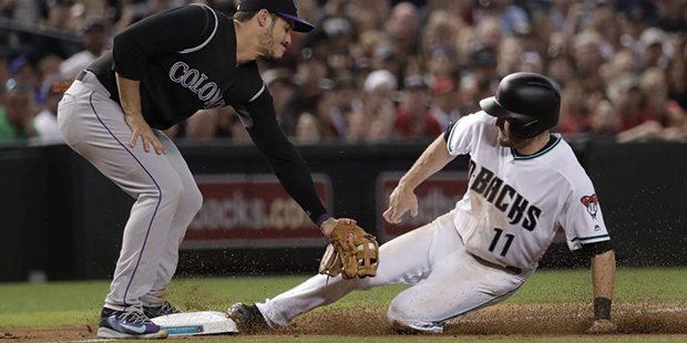 Arizona Diamondbacks A.J. Pollock (11) steals third during the fifth inning as Colorado Rockies' No...