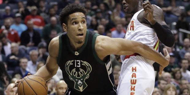 Milwaukee Bucks' Malcolm Brogdon tries to drive past Atlanta Hawks' Dennis Schroder during the firs...