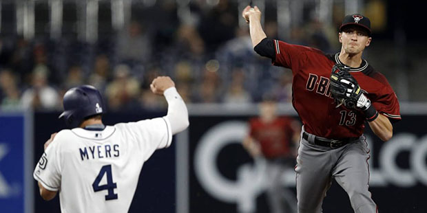 San Diego Padres' Wil Myers, left, gets forced out at second, as Arizona Diamondbacks shortstop Nic...