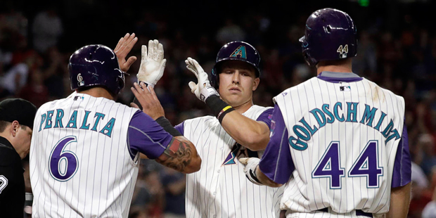 Arizona Diamondbacks Jake Lamb, center, high fives David Peralta (6) and Paul Goldschmidt (44) afte...