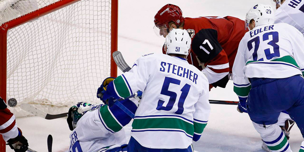 Arizona Coyotes' Radim Vrbata (17) beats Vancouver Canucks' Ryan Miller, left, for a goal as Troy S...